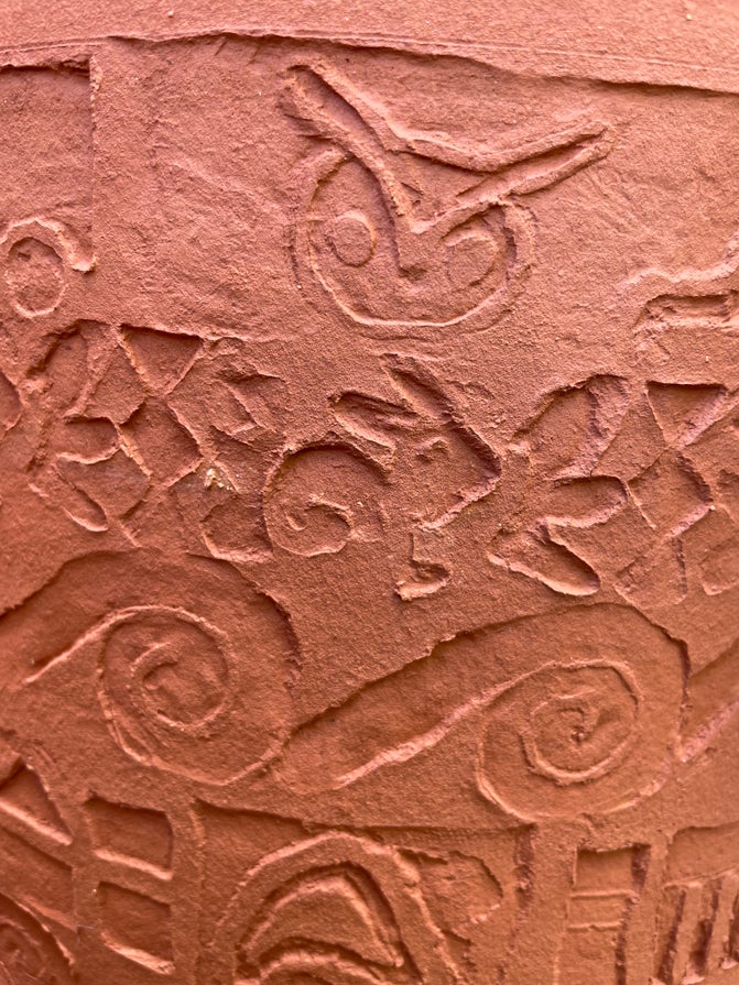 Designs applied to a chimney pot, including an owl and a rabbit